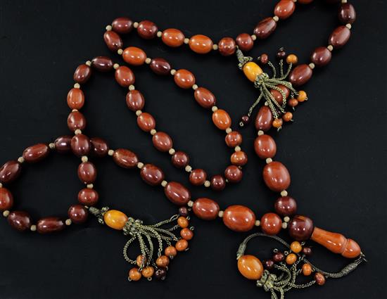 A Persian gilt metal and graduated amber bead tassel drop necklace, 180cm incl. tassel.